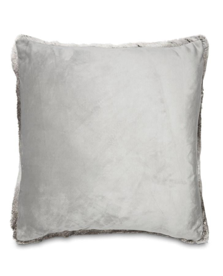 Faux fur cushion styled on bed